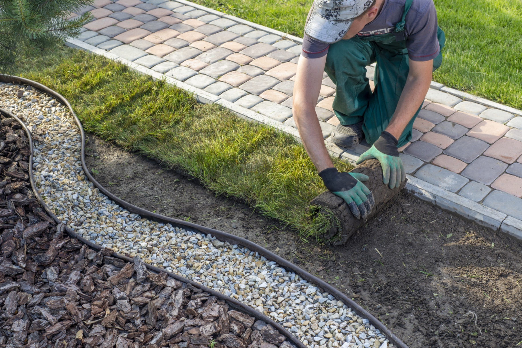 Landscaping professional laying sod for a lush lawn